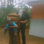 Wabup Gagarin saat membantu menjinjing tampah milik nenek renta di Desa Watupatok.